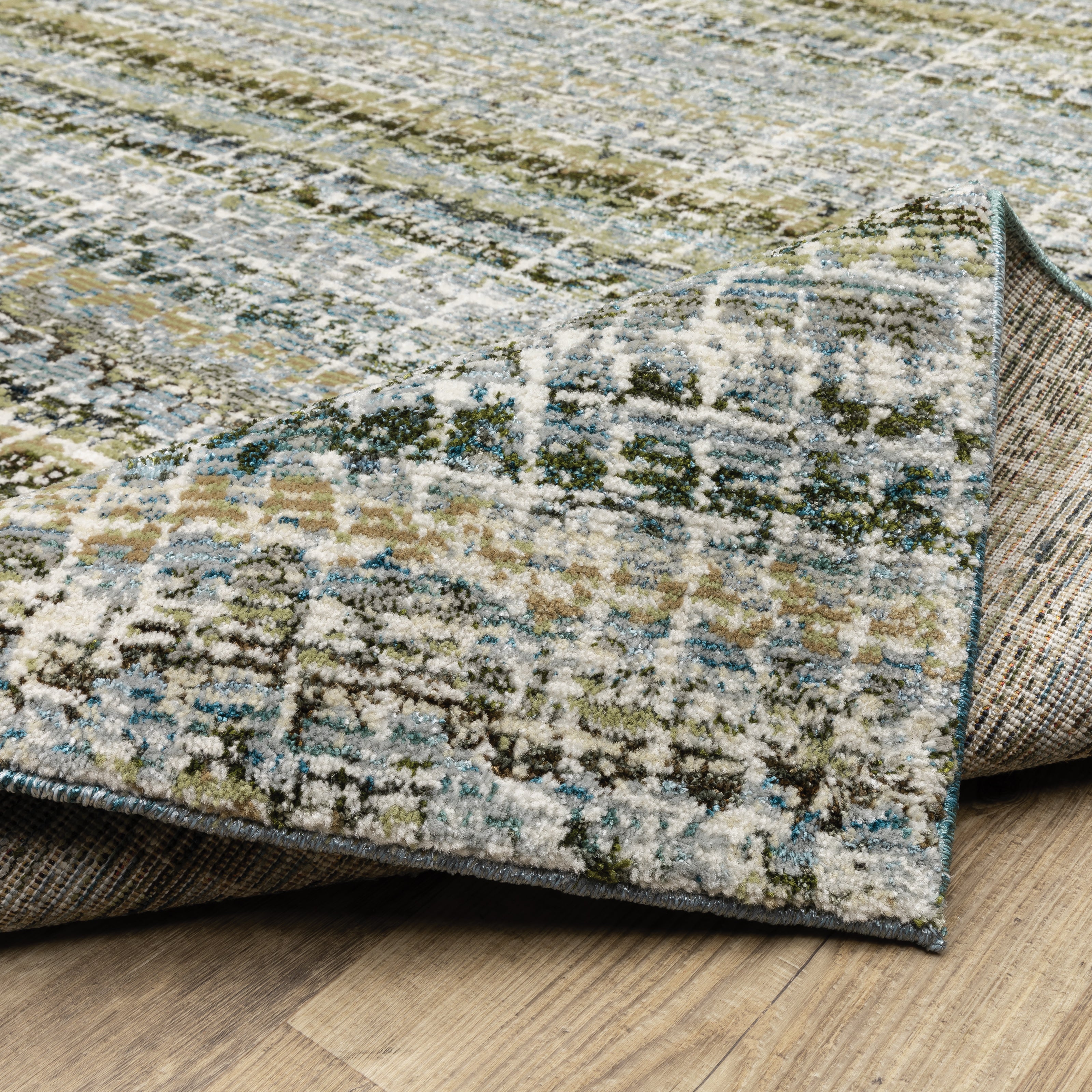 Oriental Weavers Atlas 747B0 textured area rug featuring textured design in blue/ green tones