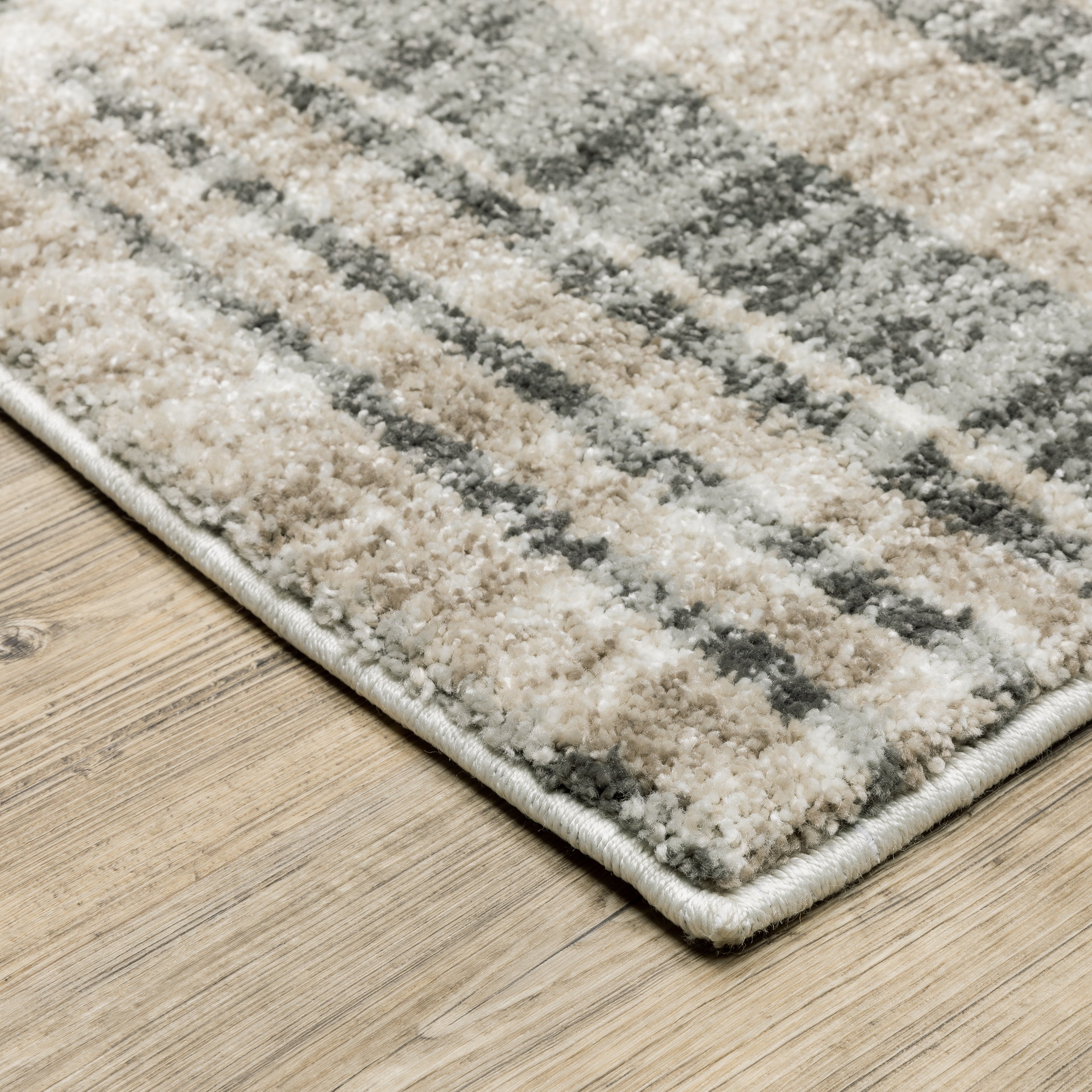 Oriental Weavers Cambria 055X2 plush modern rug featuring abstract pattern in tan/ charcoal tones