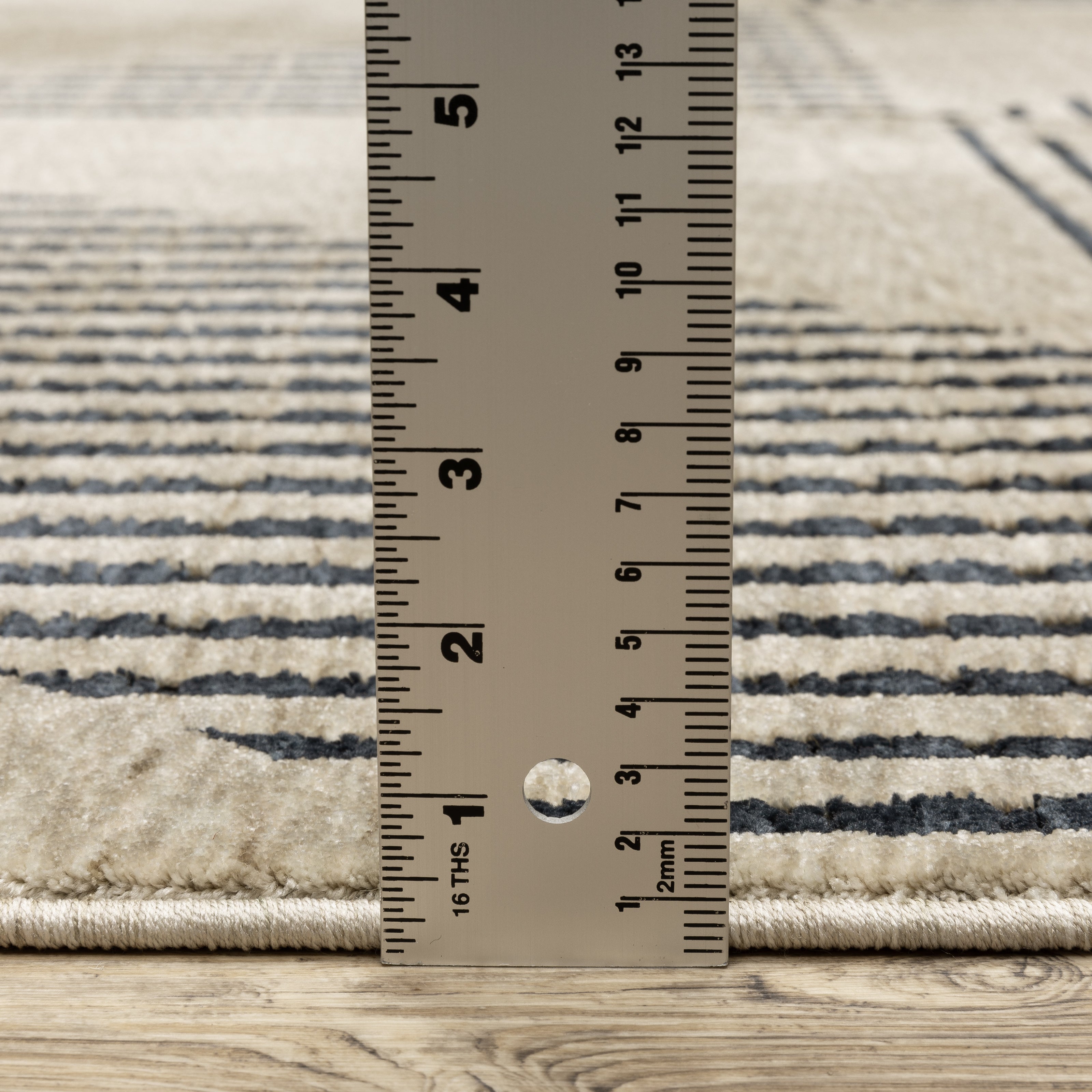 Oriental Weavers Capella CAP04 soft transitional rug featuring textured design in beige/ deep navy tones