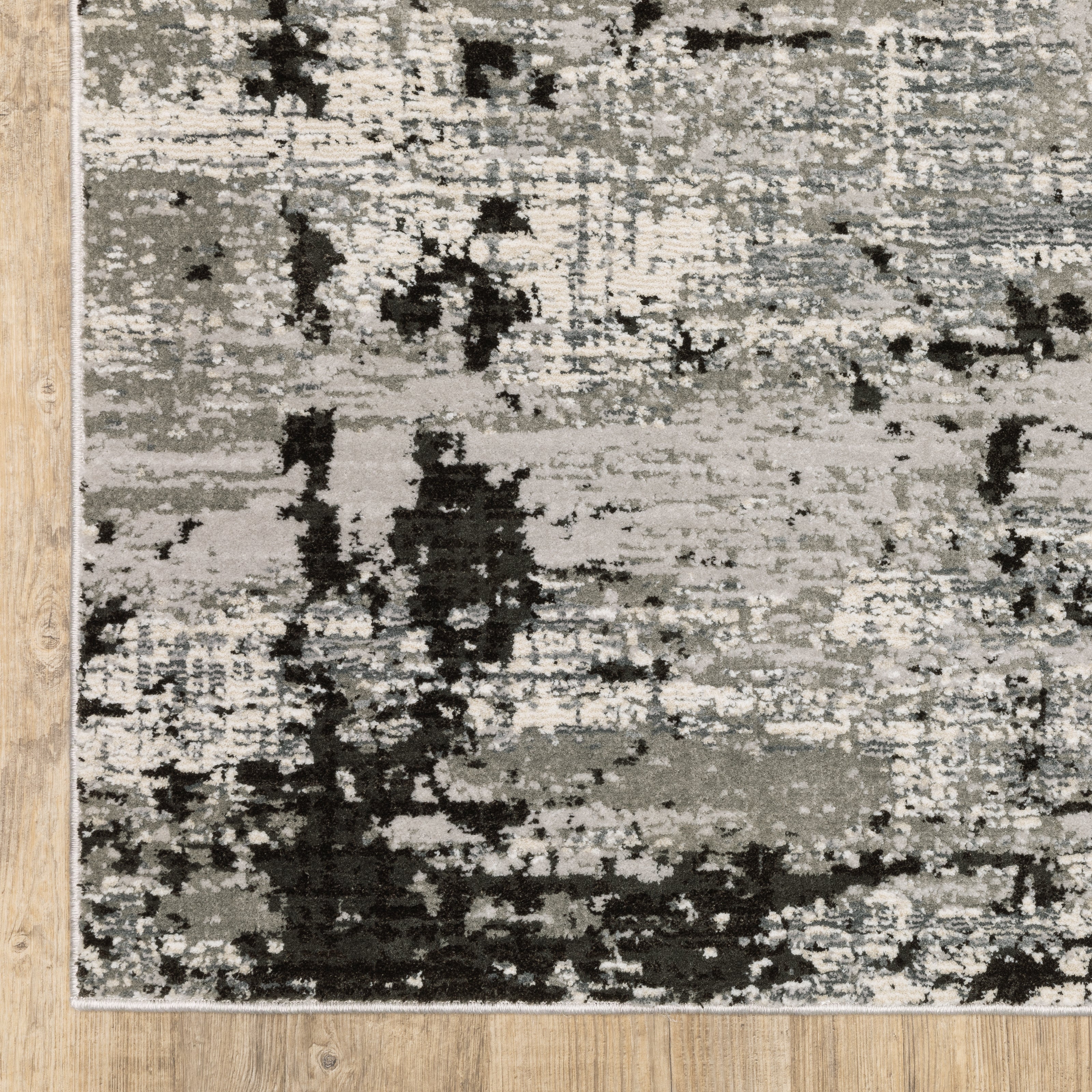 Oriental Weavers Caravan 4153Q soft area rug featuring textured design in grey/ black tones