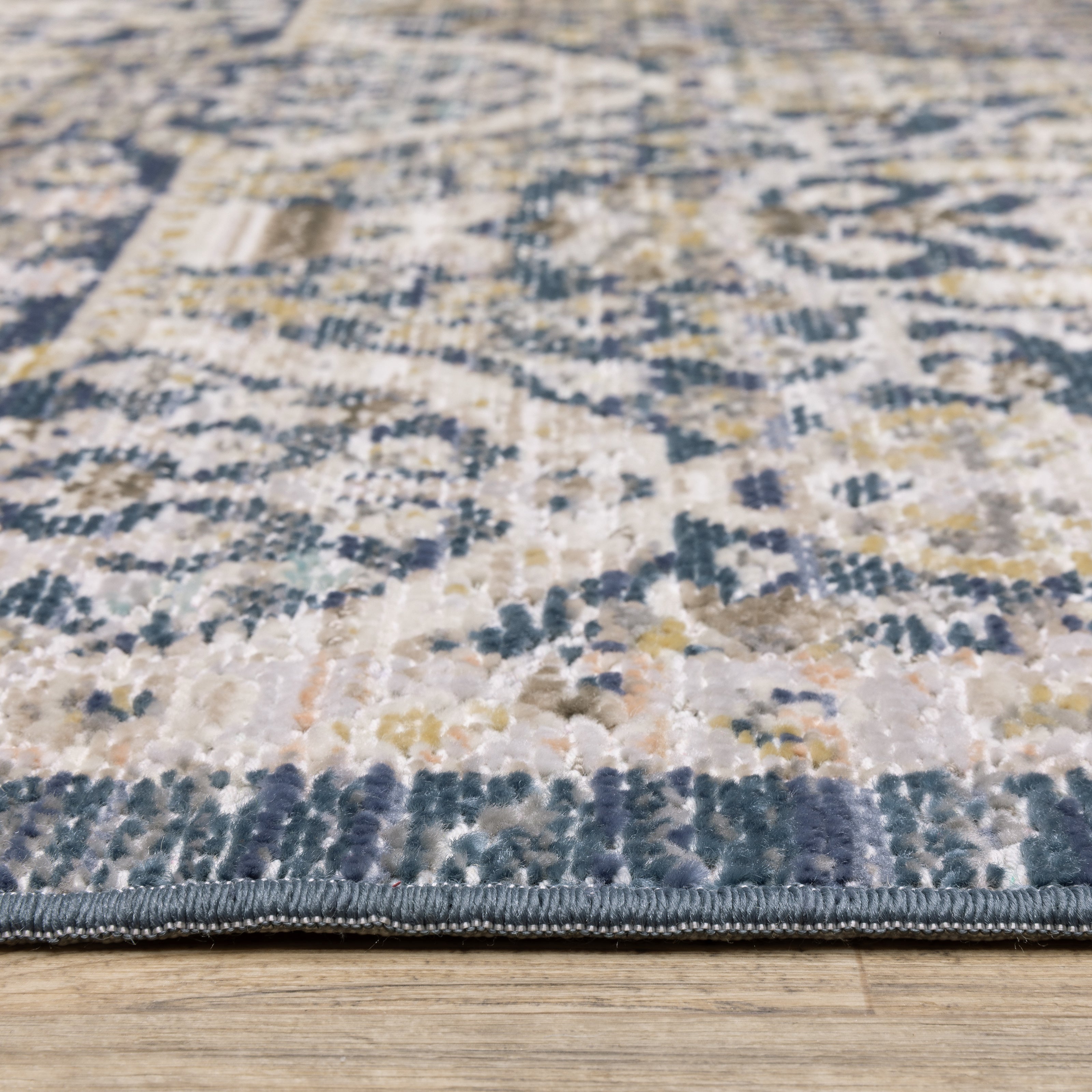 Oriental Weavers Cavett CAV06 soft transitional rug featuring decorative pattern in navy/ gold tones