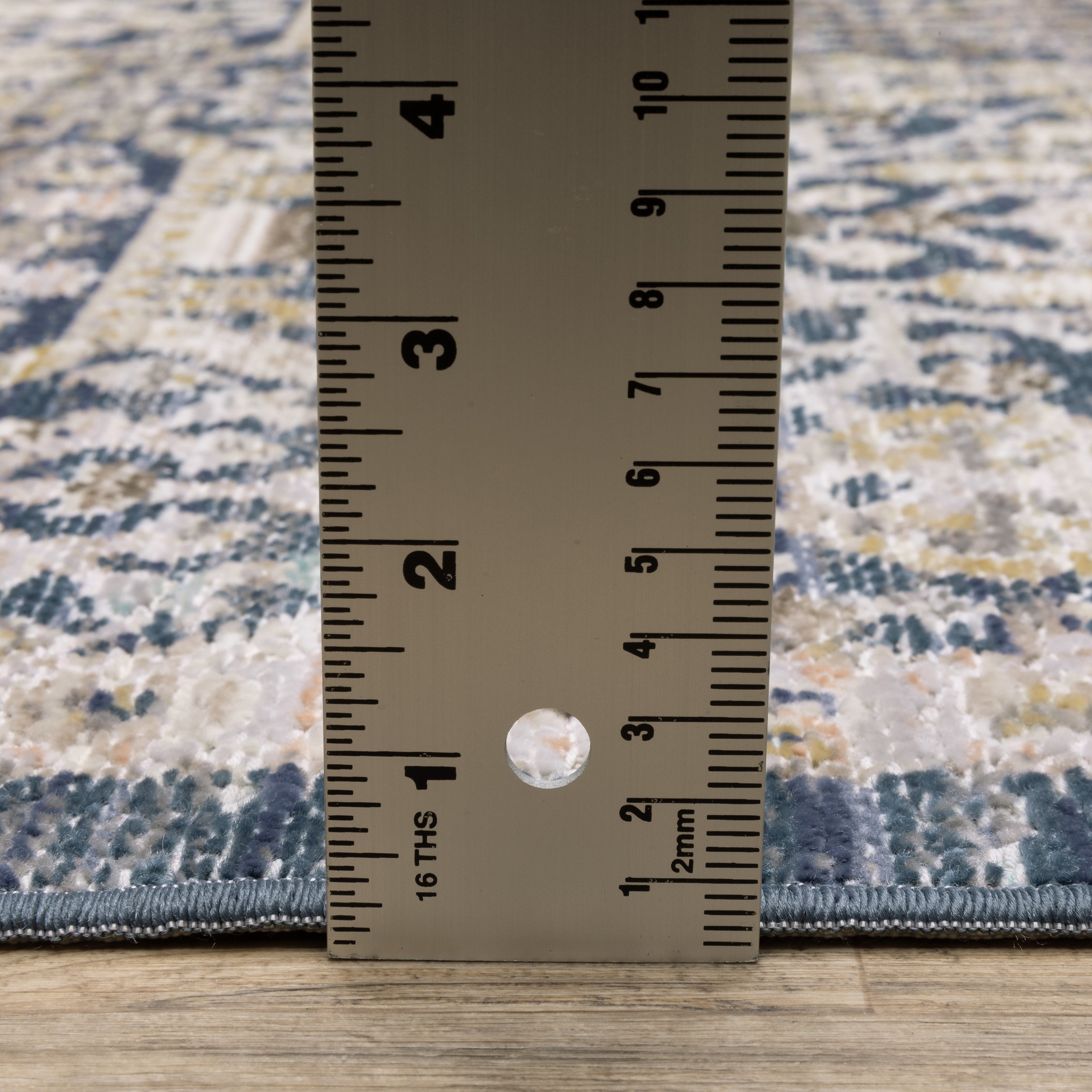 Oriental Weavers Cavett CAV06 soft transitional rug featuring decorative pattern in navy/ gold tones