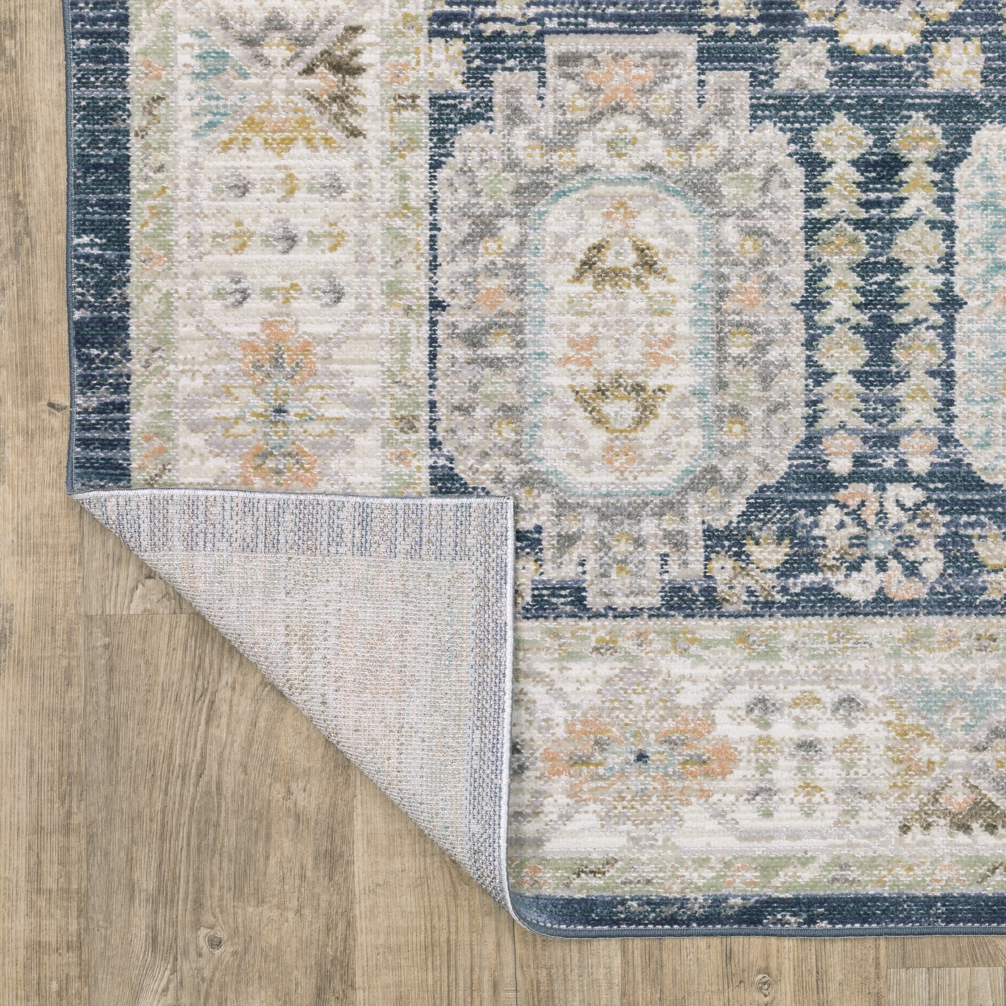 Oriental Weavers Cavett CAV07 soft transitional rug featuring decorative pattern in navy/ ivory tones