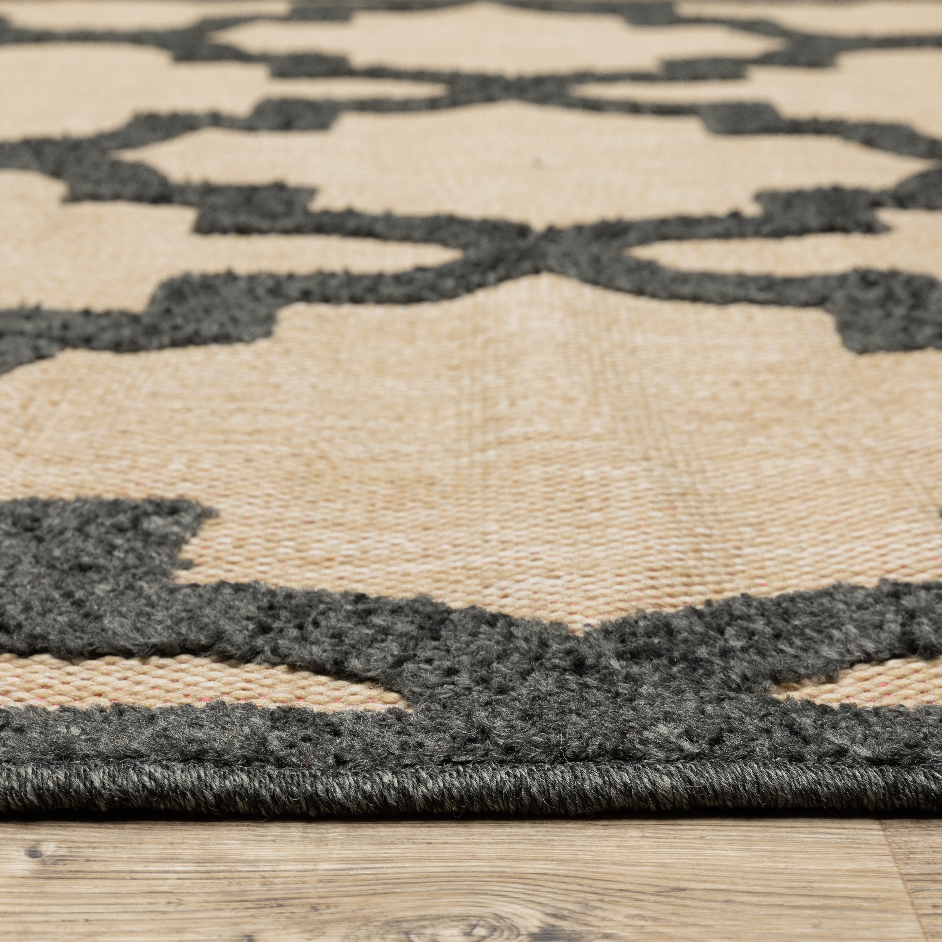 Oriental Weavers Cayman 660N9 textured indoor-outdoor rug featuring abstract pattern in sand/ charcoal tones
