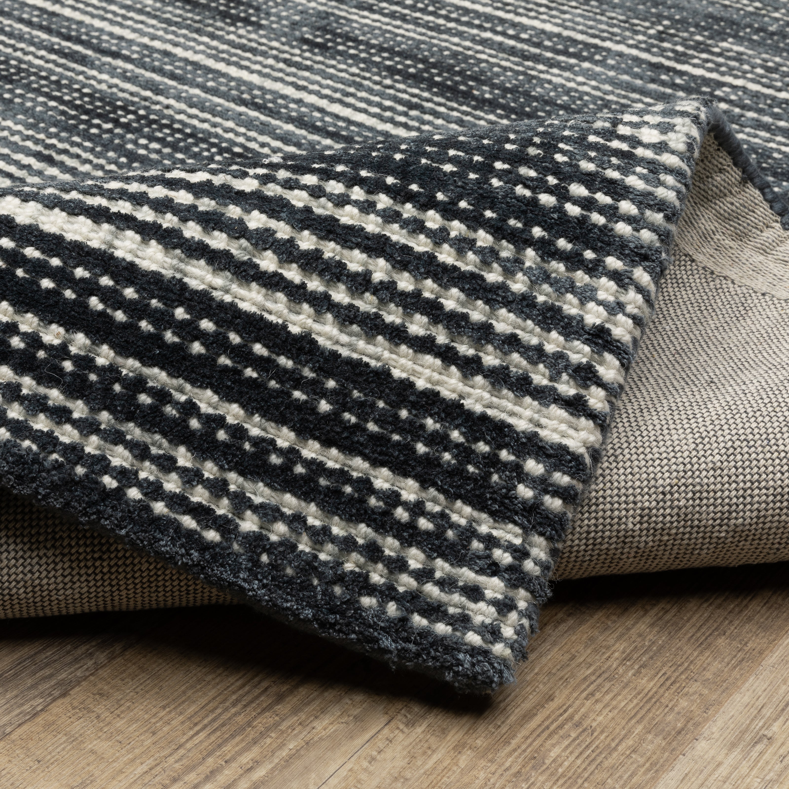 Oriental Weavers Circa CIR02 soft area rug featuring textured design in black/ ivory tones