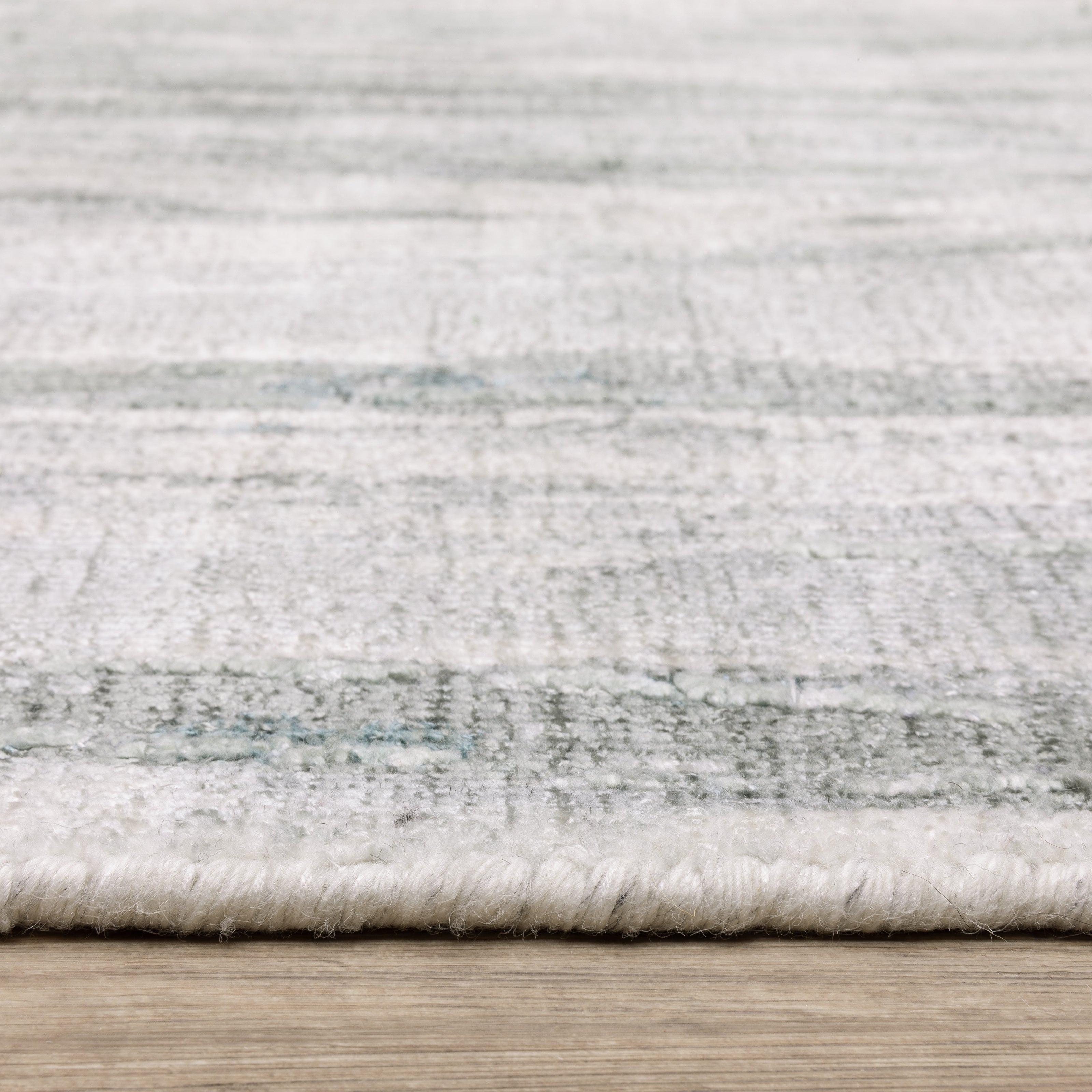 Oriental Weavers Clarke CLA03 soft modern rug featuring abstract pattern in green/ ivory tones