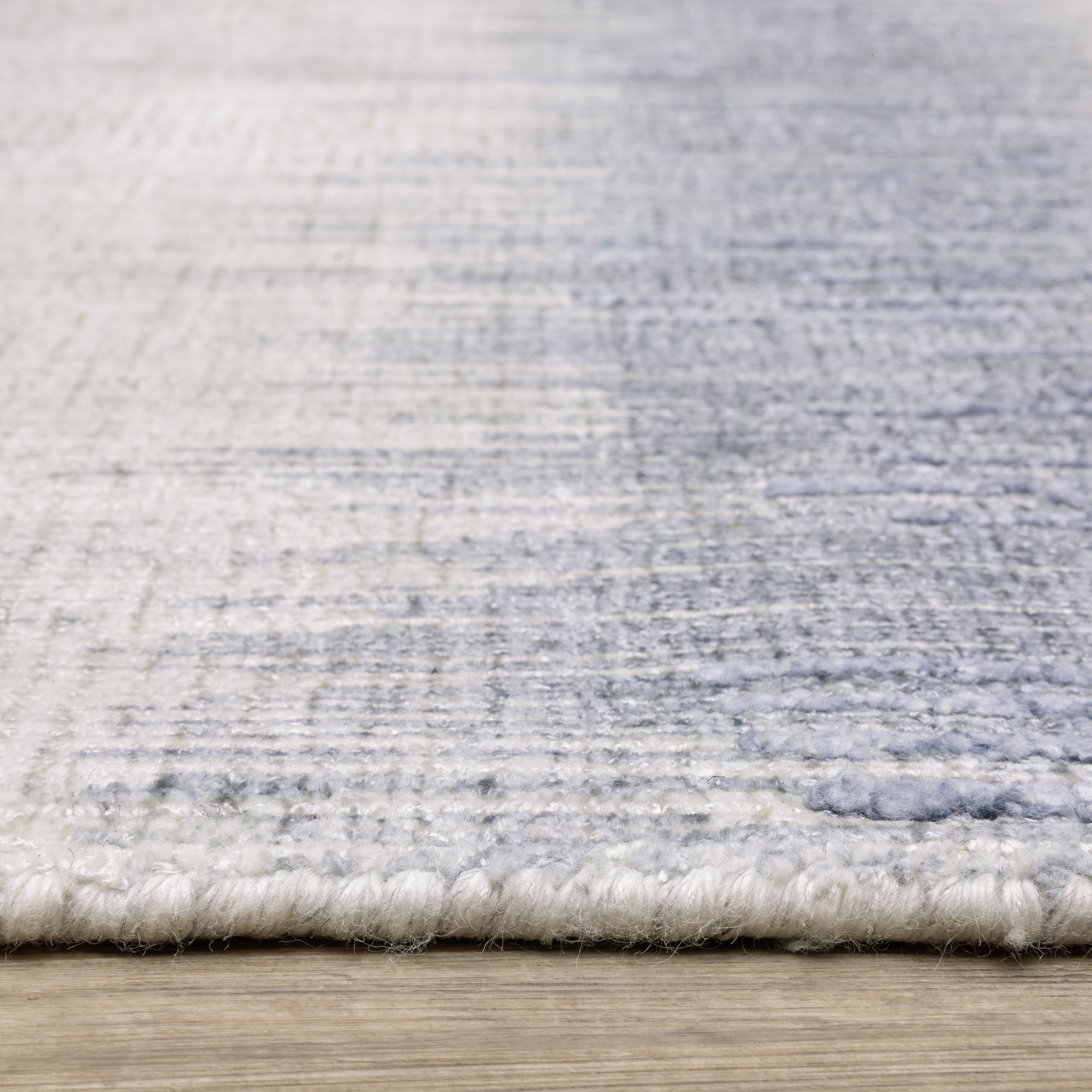 Oriental Weavers Clarke CLA06 soft modern rug featuring abstract pattern in blue/ ivory tones
