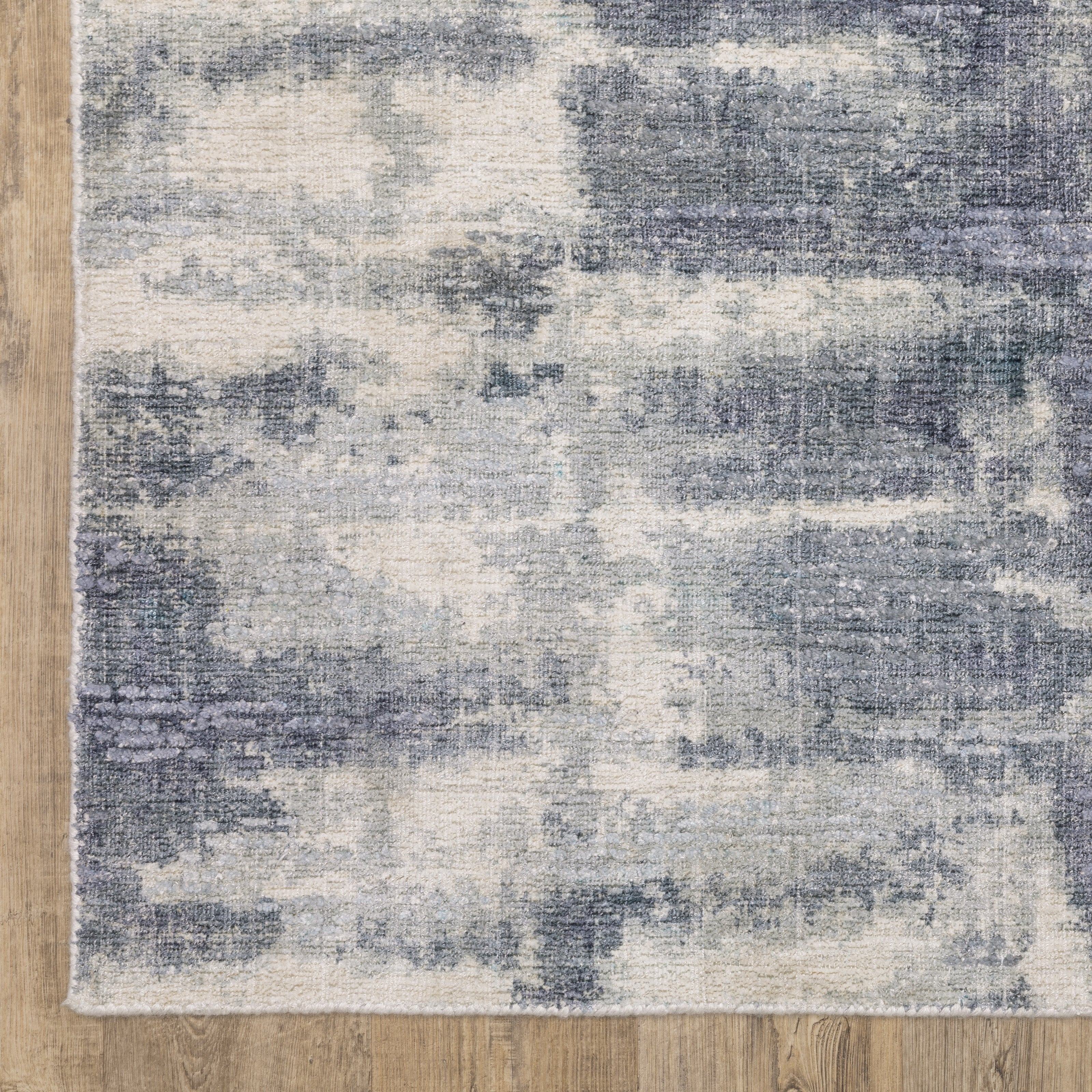 Oriental Weavers Clarke CLA07 soft modern rug featuring abstract pattern in blue/ ivory tones