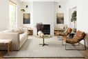 Hand-woven jute and cotton rug from the Colton Collection by Angela Rose x Loloi, featuring linear patterns in earthy tones, displayed in a modern home setting.