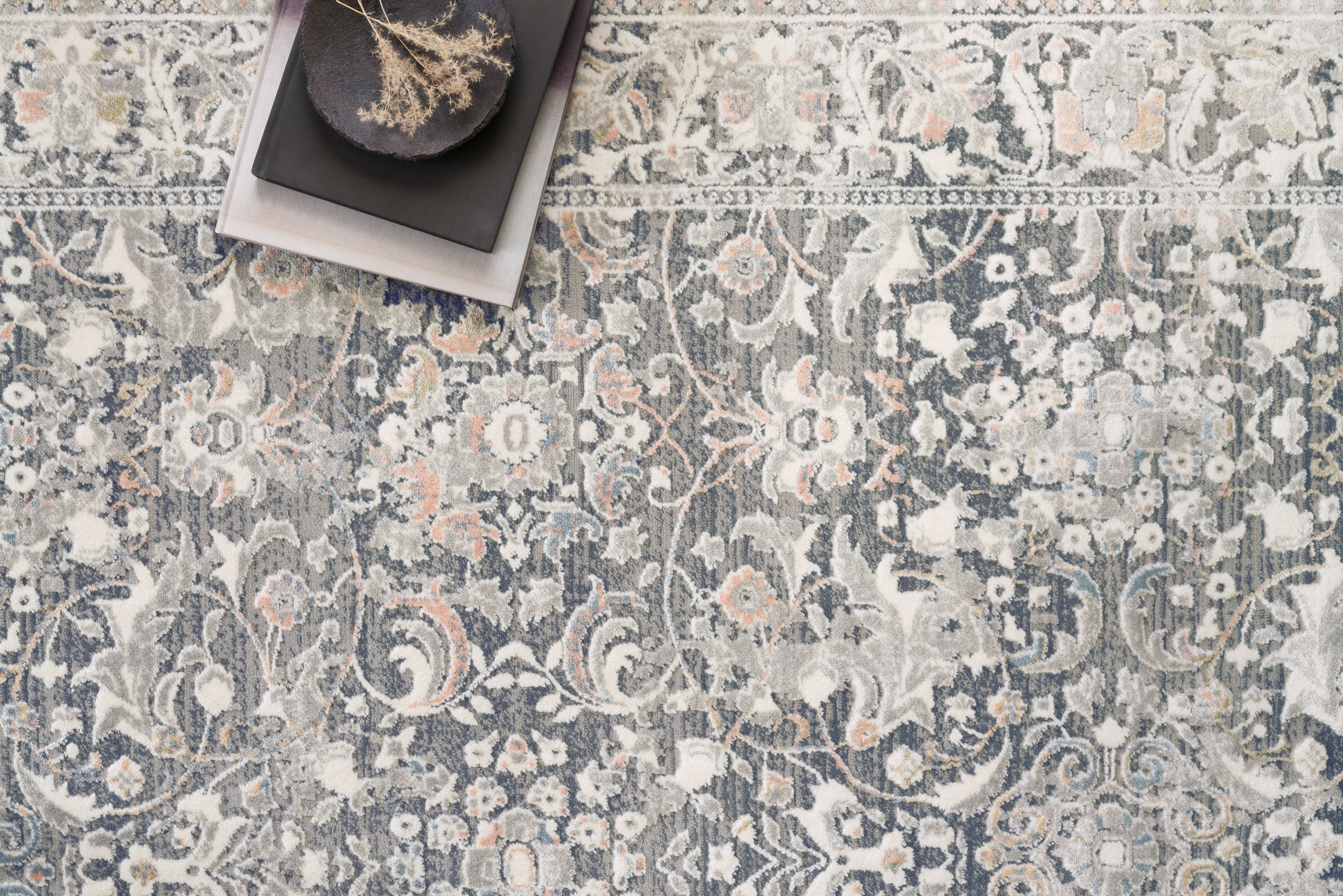Elegant Turkish power-loomed rug from the Lucia Collection featuring a high/low pile, rich colors, and durable polypropylene-polyester blend, styled in a modern living space.