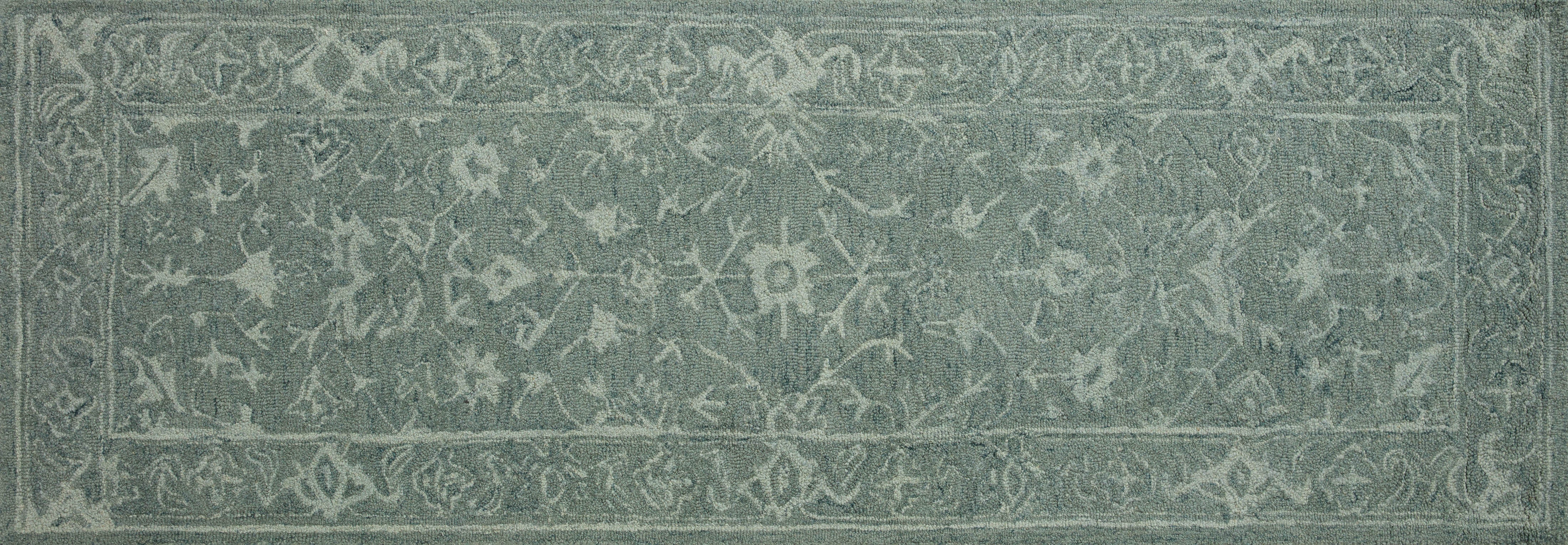 Hand-hooked Loloi Lyle Collection rug from India, made of 100% wool, with a soft texture, muted colors, traditional motifs, and Good Weave certification.