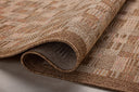 Area rug from the Loloi Merrick Collection in warm rust tones, featuring a clean-lined design, made in Egypt from durable polypropylene, suitable for indoor or outdoor use.