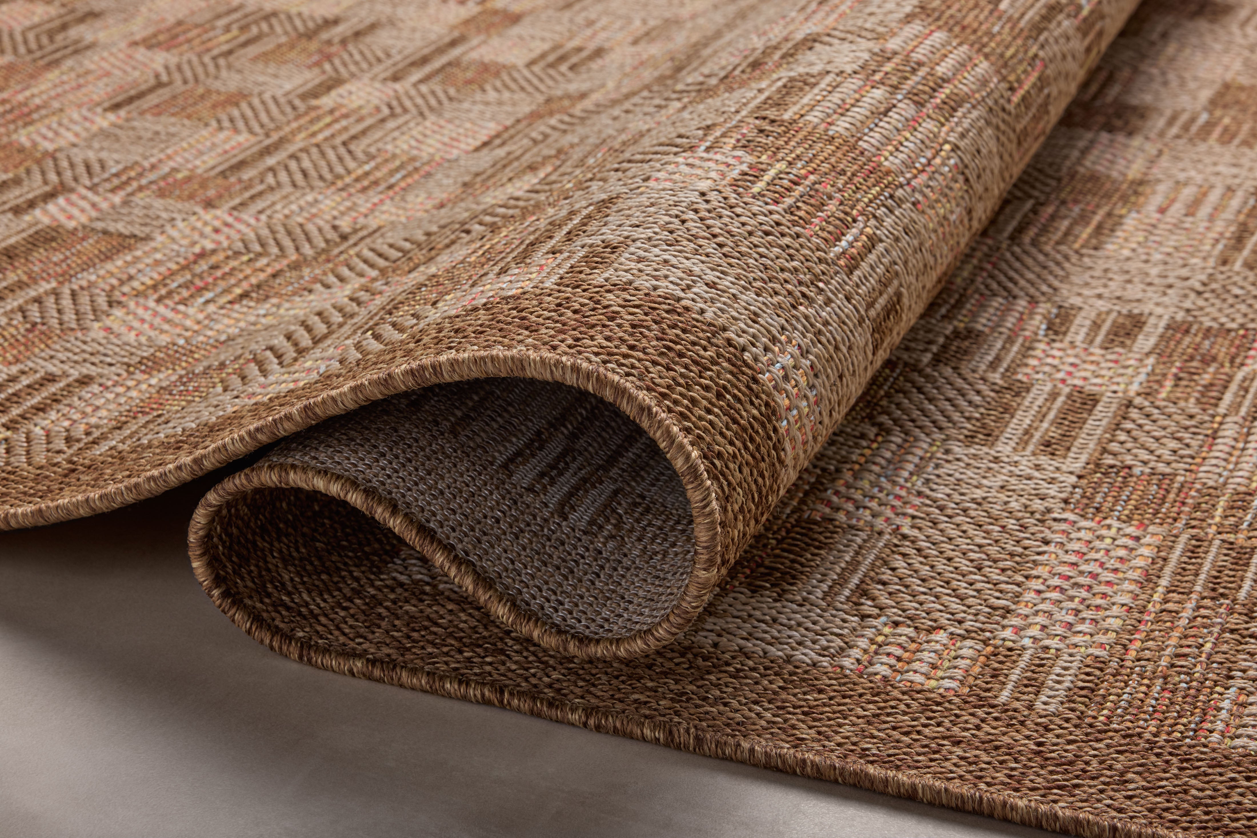 Area rug from the Loloi Merrick Collection in warm rust tones, featuring a clean-lined design, made in Egypt from durable polypropylene, suitable for indoor or outdoor use.