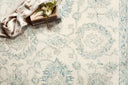 Norabel Collection area rug featuring botanical motifs in delicate, variegated colors, hooked from 100% wool by artisans in India and GoodWeave certified for ethical craftsmanship.