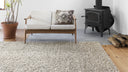 Loloi Quarry Collection hand-woven rugs in three neutral shades of stone, oatmeal, and ivory, blending wool, polyester, and cotton. Ethically made with GoodWeave certification.