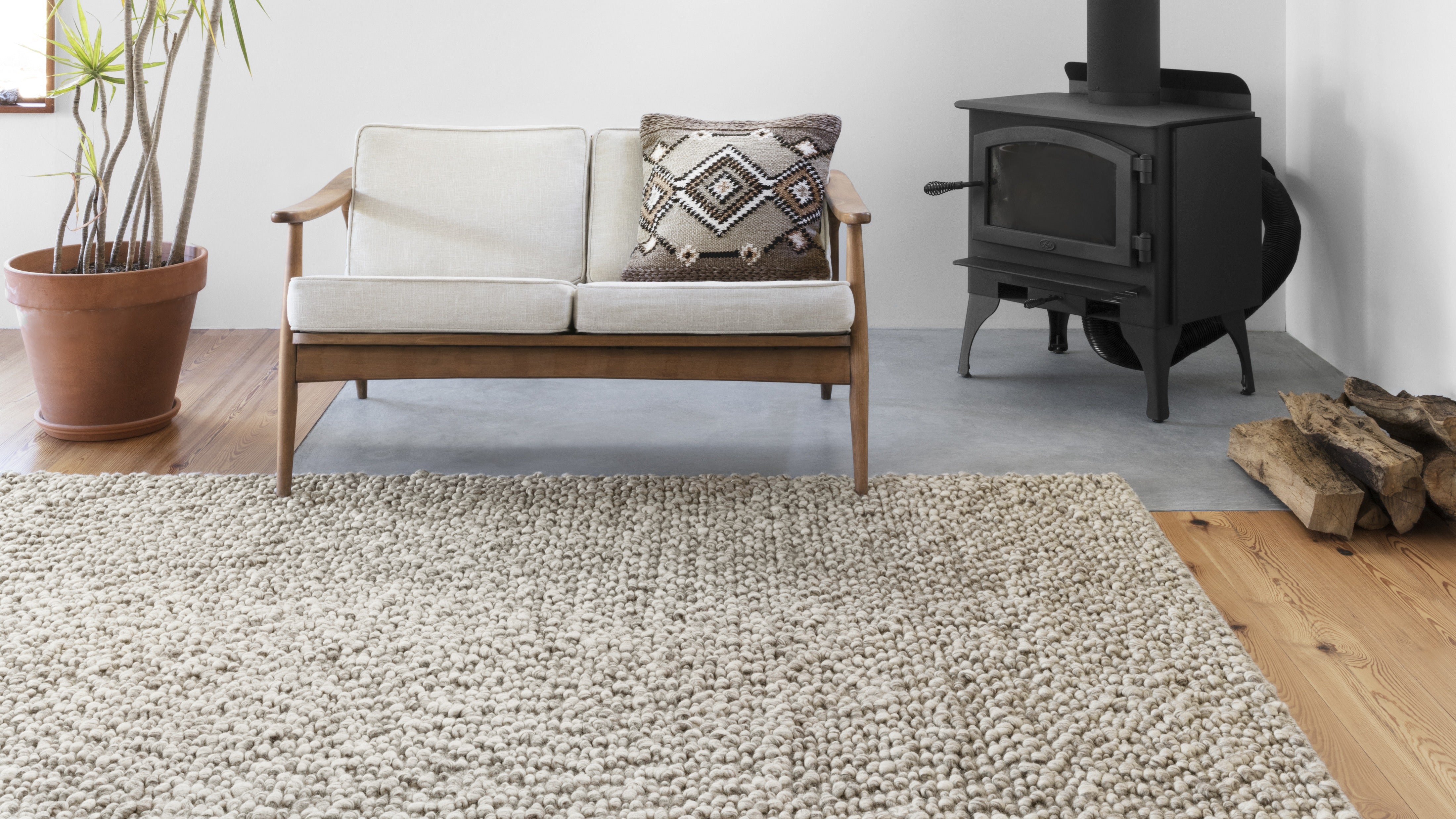 Loloi Quarry Collection hand-woven rugs in three neutral shades of stone, oatmeal, and ivory, blending wool, polyester, and cotton. Ethically made with GoodWeave certification.