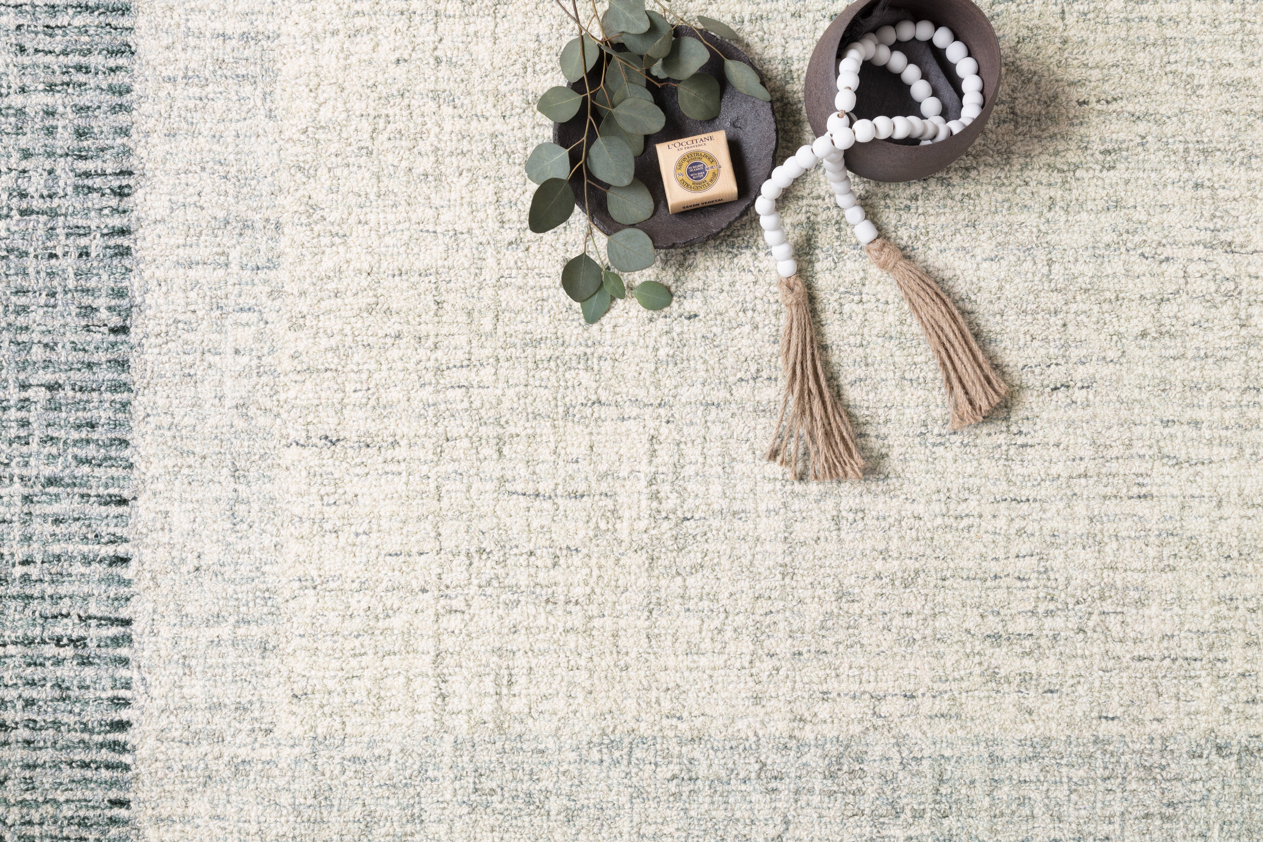 A hand-tufted wool rug from the Rosina Collection, featuring vibrant variegated yarns. The rug highlights exquisite craftsmanship and adds style to the interior, while supporting ethical production.
