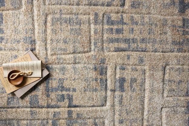 Modern polypropylene Loloi Silas collection area rug featuring neutral tones, geometric design, gentle fading, and black accents.