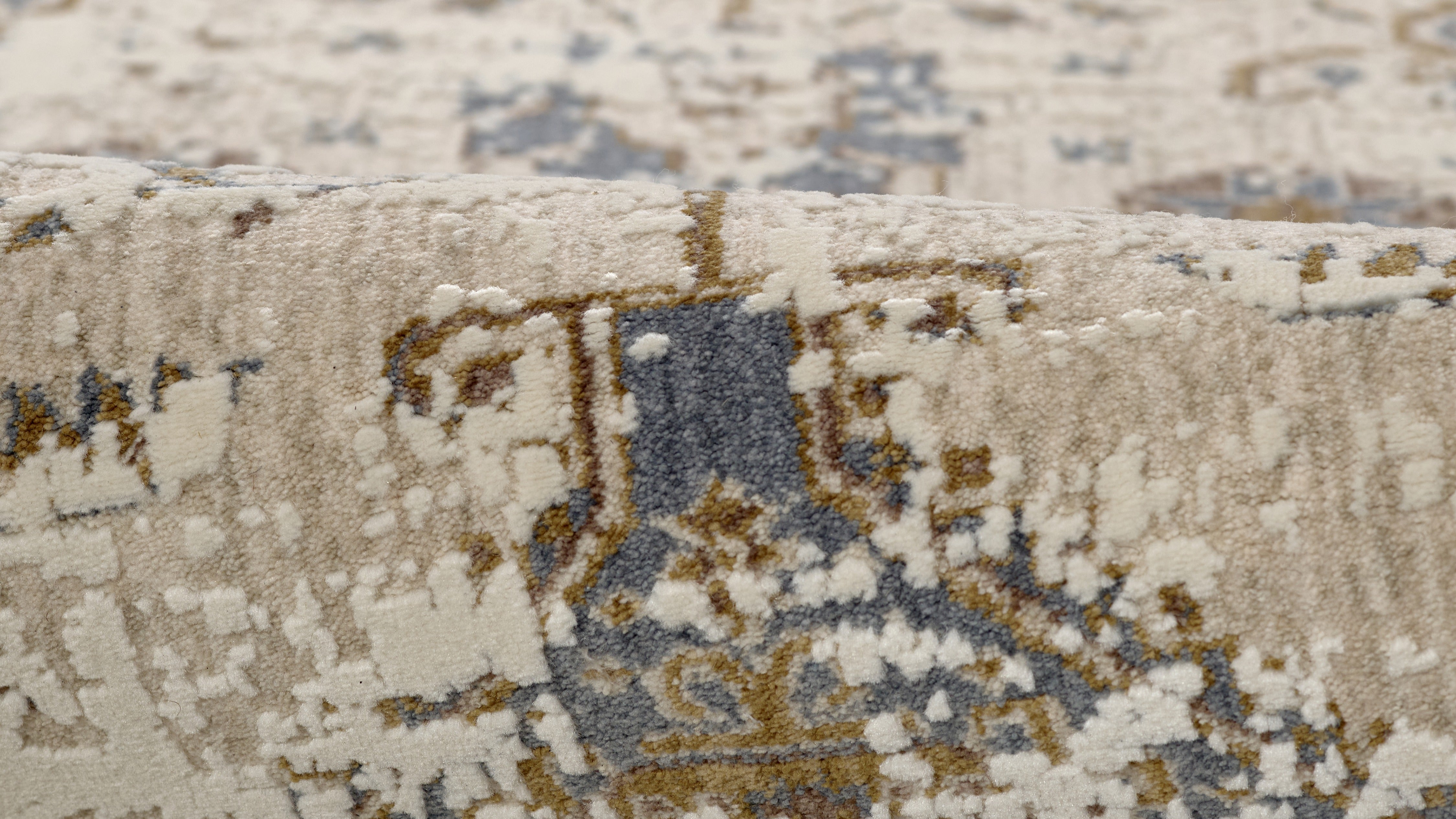 A modern Momeni Vera Collection rug with abstract patterns and a soft texture. This durable rug, made from a polyester and polypropylene blend, features a subtle sheen that enhances its contemporary design.