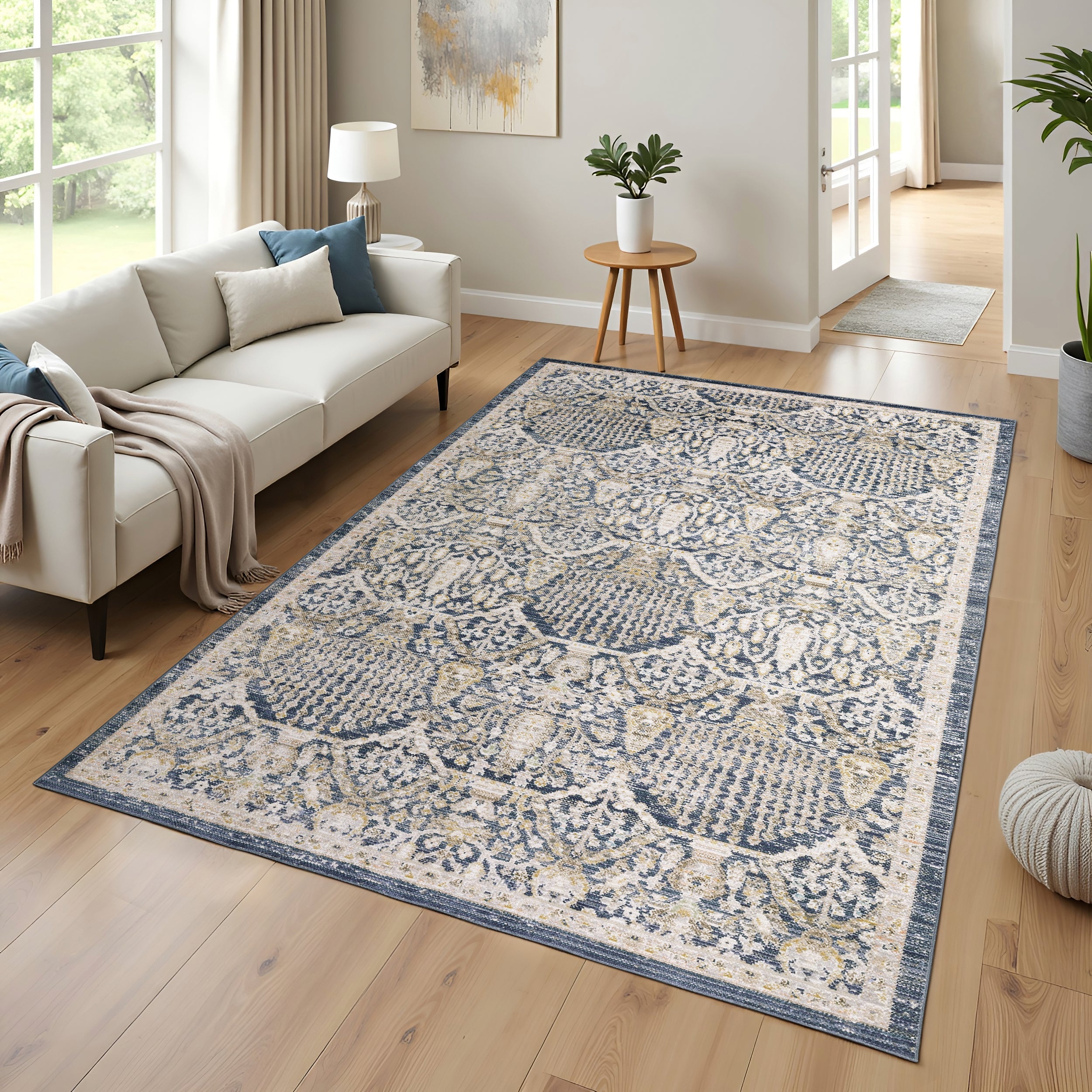 Oriental Weavers Cavett collection, low-profile area rugs are crafted from soft, resilient synthetic fibers, showcasing a washed palette of navy, teal, and green, beautifully complemented by gentle hues of clay and gold.