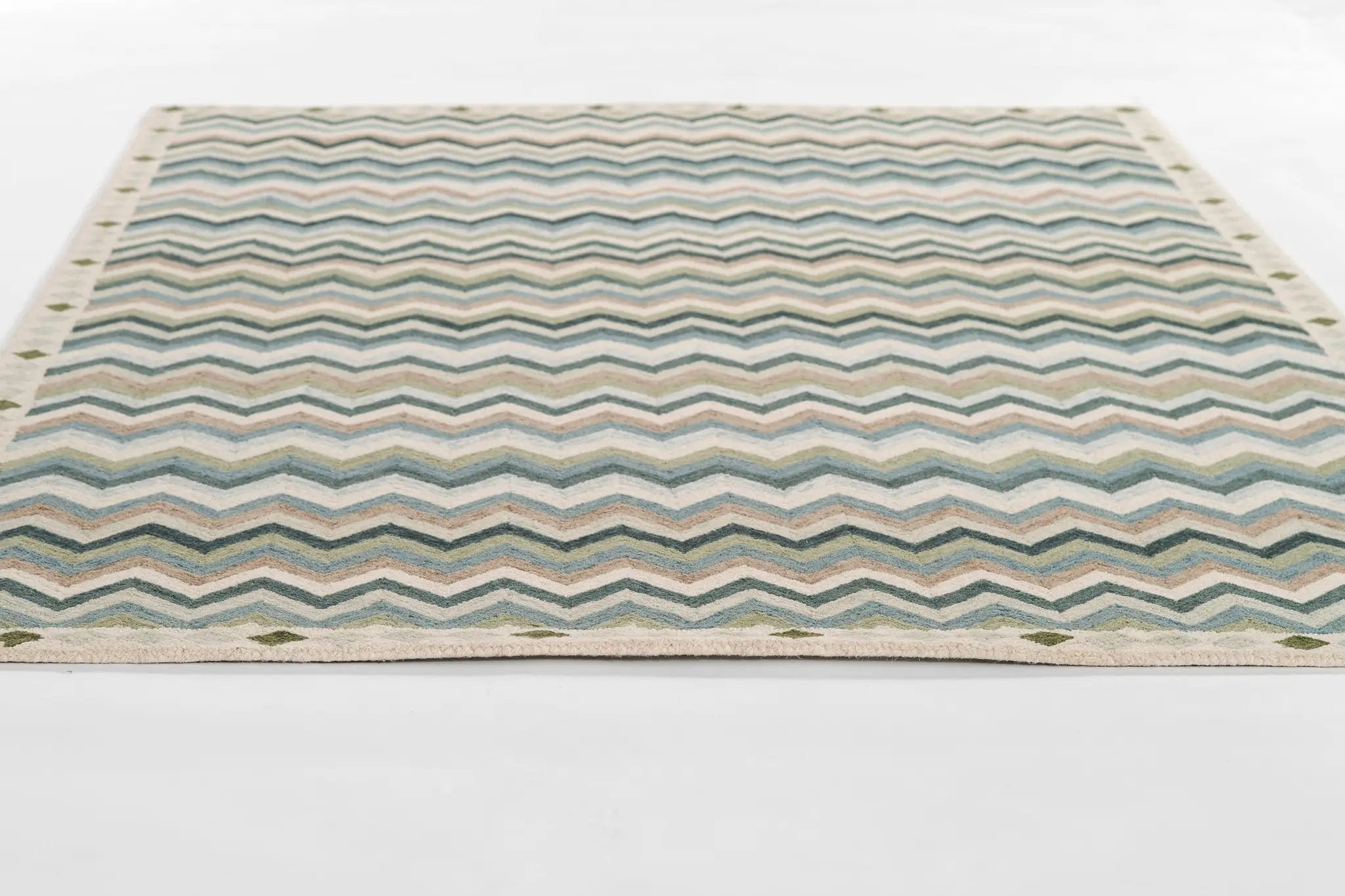 Erin Gates by Momeni Abbot ABB-1 Blue Area Rug features a hand-tufted wool chevron pattern in blue, green, and beige with a dotted border.