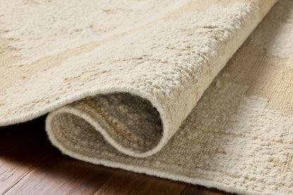 Designed in refined ivory and warm natural hues, the Alara ALR-03 Ivory / Natural Area Rug is a hand-woven wool area rug that stands out