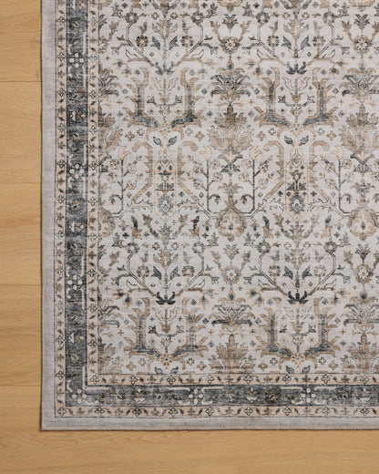 A power-loomed polyester area rug in refined ivory and grounding stone tones with traditional and distressed motifs, the Anniston ANS-01 Ivory / Stone Area Rug grounds your room beautifully
