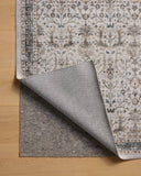 A power-loomed polyester area rug in refined ivory and grounding stone tones with traditional and distressed motifs, the Anniston ANS-01 Ivory / Stone Area Rug grounds your room beautifully