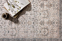 A power-loomed polyester area rug in refined ivory and grounding stone tones with traditional and distressed motifs, the Anniston ANS-01 Ivory / Stone Area Rug grounds your room beautifully
