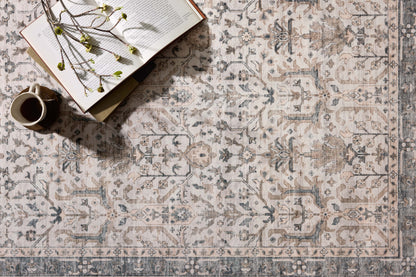 A power-loomed polyester area rug in refined ivory and grounding stone tones with traditional and distressed motifs, the Anniston ANS-01 Ivory / Stone Area Rug grounds your room beautifully