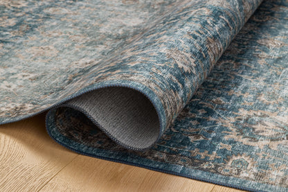 The Anniston ANS-02 Lagoon / Natural Area Rug is a power-loomed polyester area rug that radiates tranquil lagoon and warm natural charm and traditional and distressed elegance