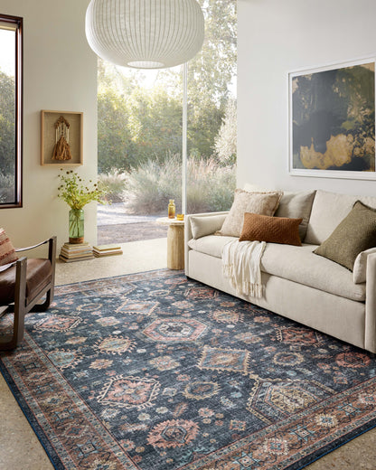 Layered in casual denim and glowing sunset hues with traditional and distressed patterns, the Anniston ANS-03 Denim / Sunset Area Rug is a power-loomed polyester area rug perfect for any setting