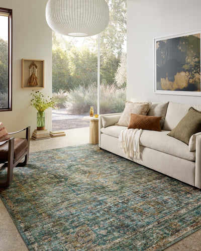 Featuring tranquil lagoon and vibrant multi-toned hues and traditional and distressed detail, the Anniston ANS-05 Lagoon / Multi Area Rug is a power-loomed polyester area rug for any room