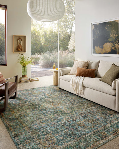 Featuring tranquil lagoon and vibrant multi-toned hues and traditional and distressed detail, the Anniston ANS-05 Lagoon / Multi Area Rug is a power-loomed polyester area rug for any room