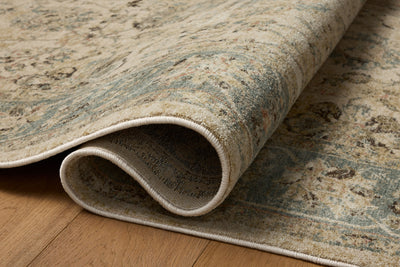 The Briar BRR-05 Ant. Ivory / Blue Area Rug is a power-loomed polyester area rug that radiates ant. ivory and calming blue charm and contemporary and traditional elegance