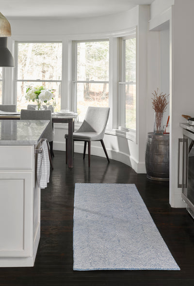 Charles CHR-1 Blue Area Rug with a blue and white herringbone pattern on dark wood floors.
