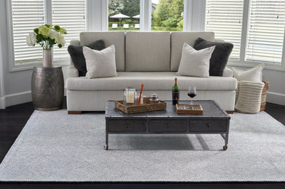 Charles CHR-1 Blue Area Rug with a white herringbone pattern under a sofa and coffee table.