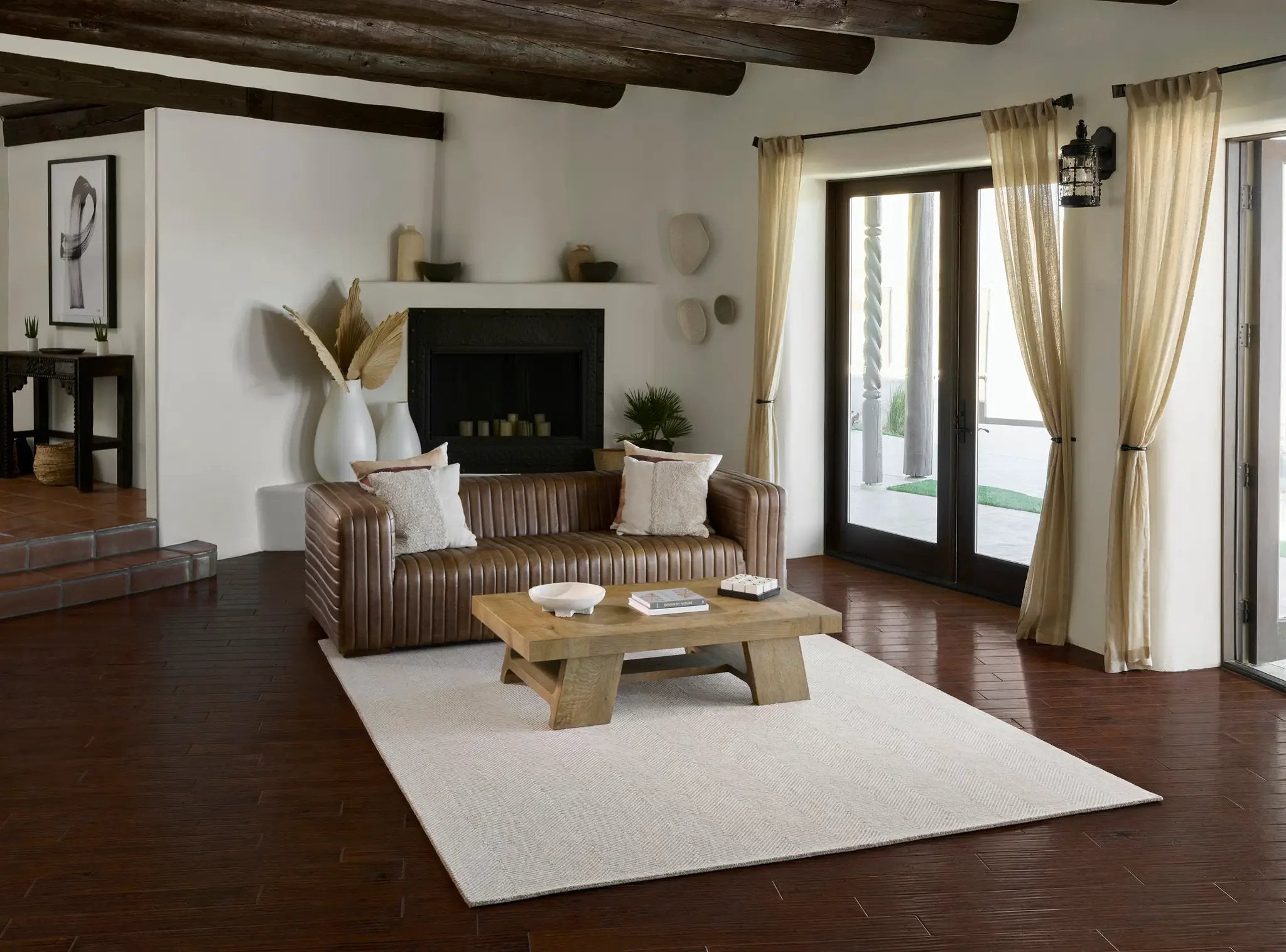 Charles CHR-1 Taupe Area Rug with a herringbone pattern in a living room with a leather sofa.