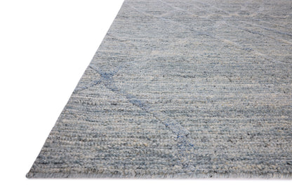 The Cline CLI-01 Sky Area Rug blends breezy sky-blue tones into a hand-woven 100% wool area rug with timeless appeal