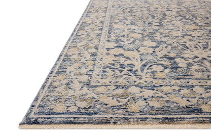 A power-loomed polyester area rug with traditional and floral design in calming blue and warm beige hues, the Clarisse CLS-05 Blue / Beige Area Rug is a standout in any décor