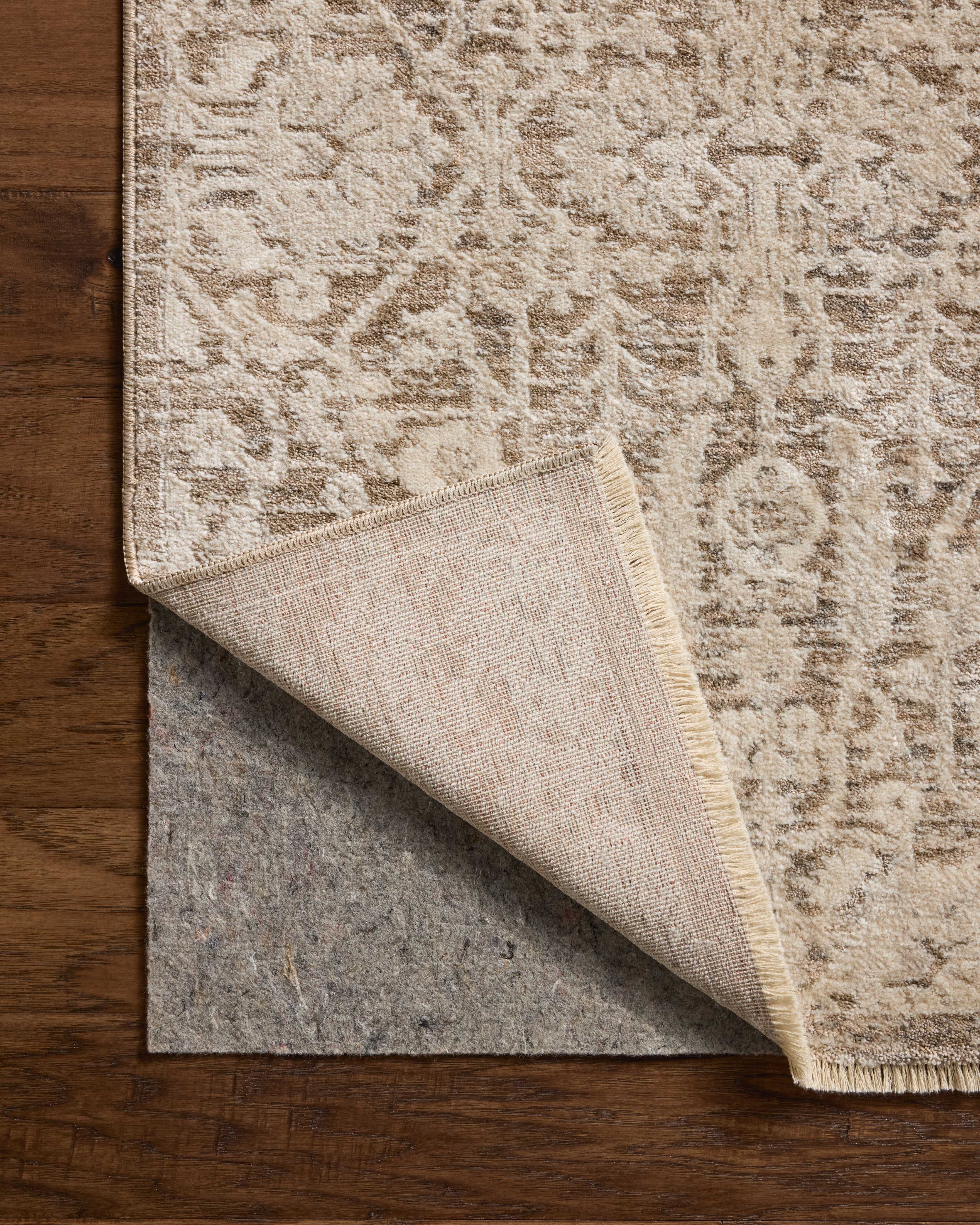 Dressed in misty and bone hues with traditional and floral detail, the Clarisse CLS-06 Fog / Bone Area Rug is a power-loomed polyester area rug that completes any room