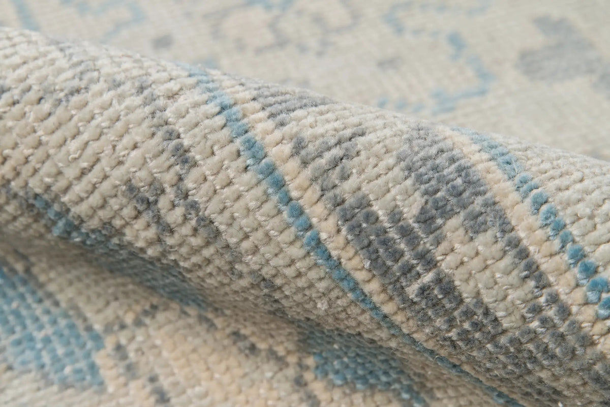 Close-up texture of rolled Erin Gates by Momeni Concord CRD-3 (Lowell) Ivory Area Rug showing soft woven pile and traditional geometric detailing.