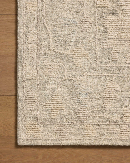 The Cynthia CYN-04 Sky / Natural Area Rug pairs breezy sky-blue and warm natural tones and floral patterns in a hand-tufted wool area rug