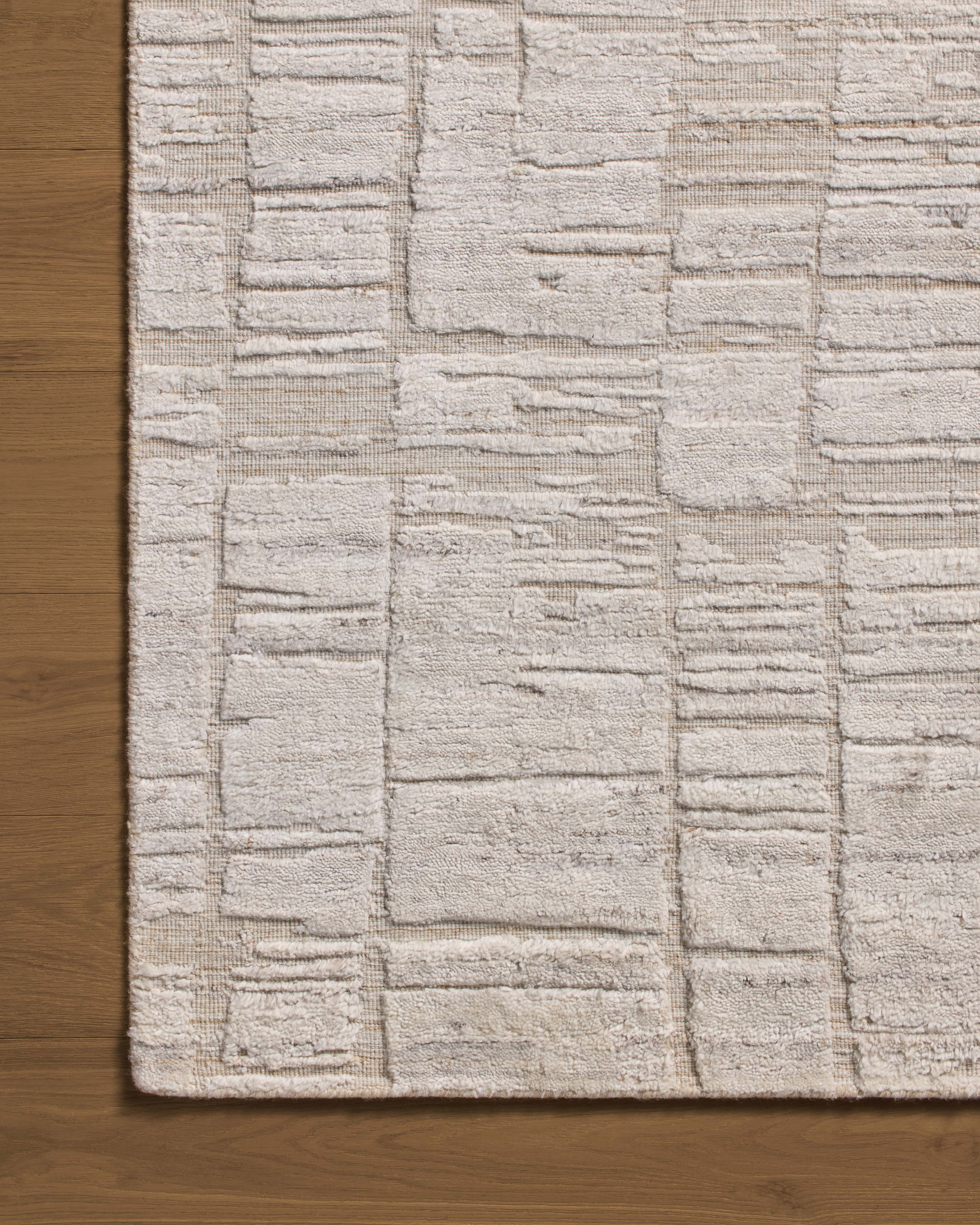 Rich in antique ivory hues with ribbed and graphic detail, the Daniel DAN-01 Antique Ivory Area Rug is a hand-loomed bamboo and wool area rug built for style and comfort