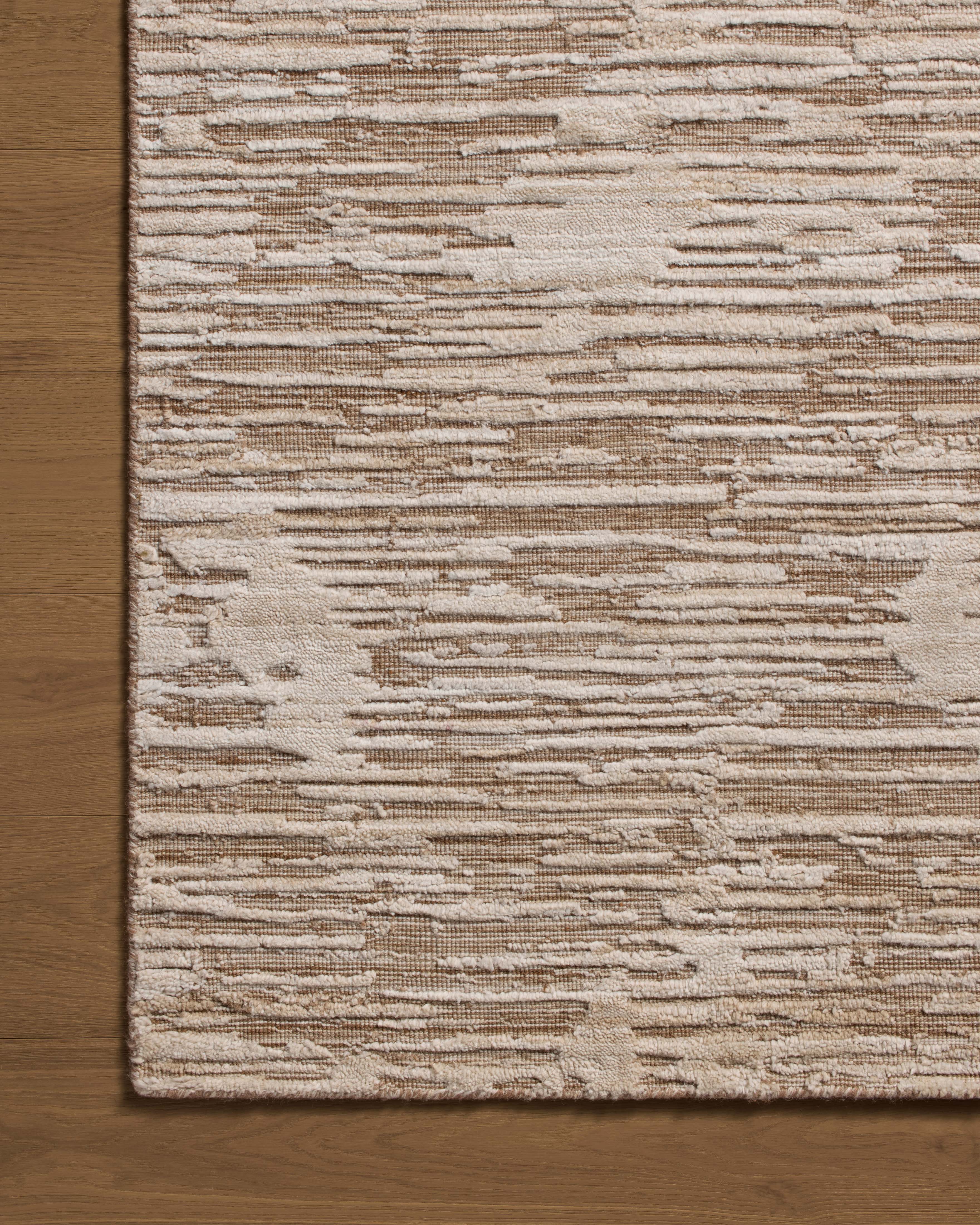 Finished in warm natural tones with ribbed and graphic styling, the Daniel DAN-02 Natural Area Rug is a hand-loomed bamboo and wool area rug for modern living
