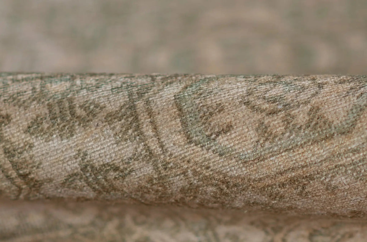 Close-up texture of the rolled Erin Gates by Momeni Dorset DOR-1 green area rug, showcasing its vintage-inspired woven pattern and durable construction.