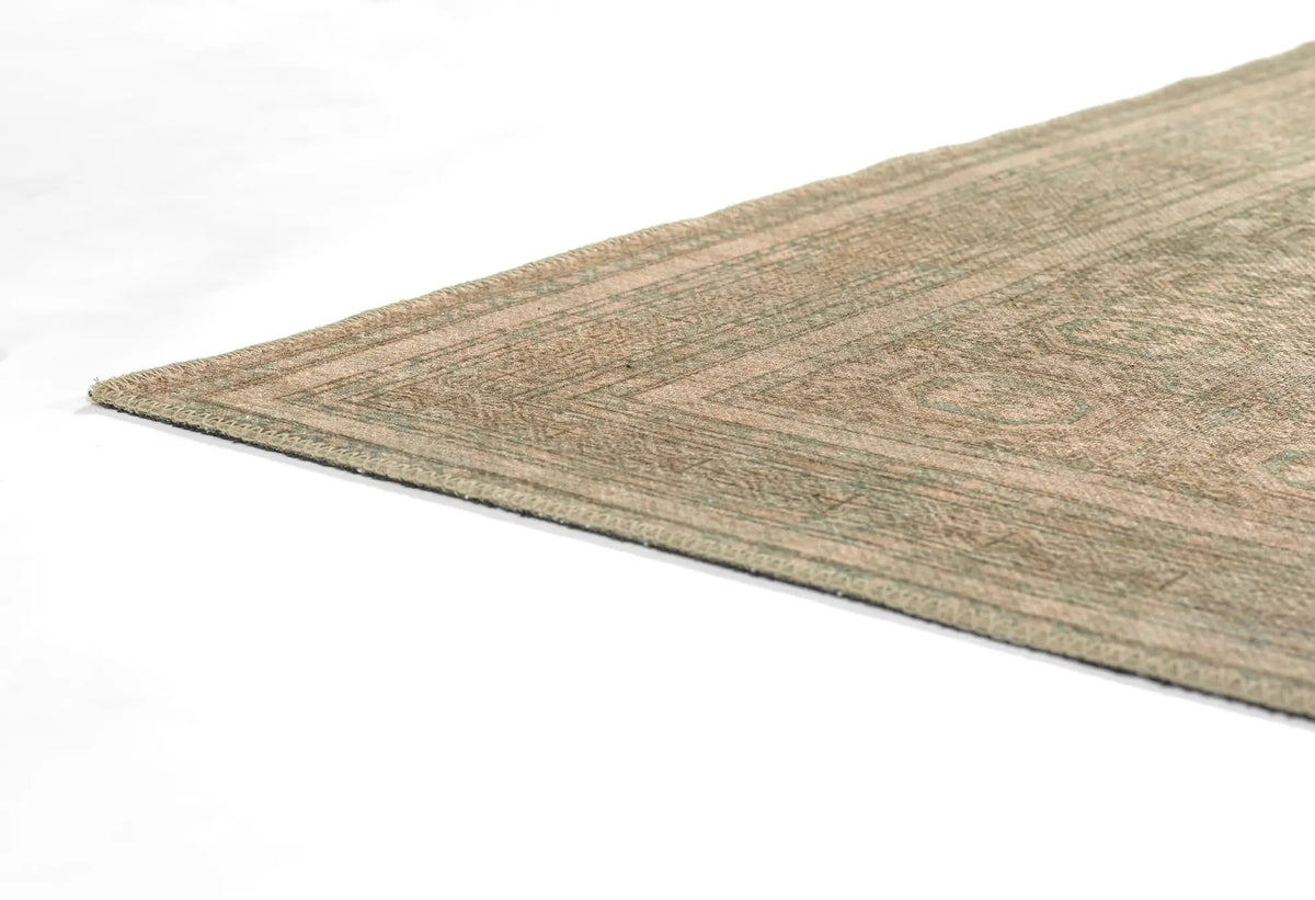 Erin Gates by Momeni Dorset DOR-1 green area rug corner showing vintage pattern, textured weave, and bordered edge on white background.