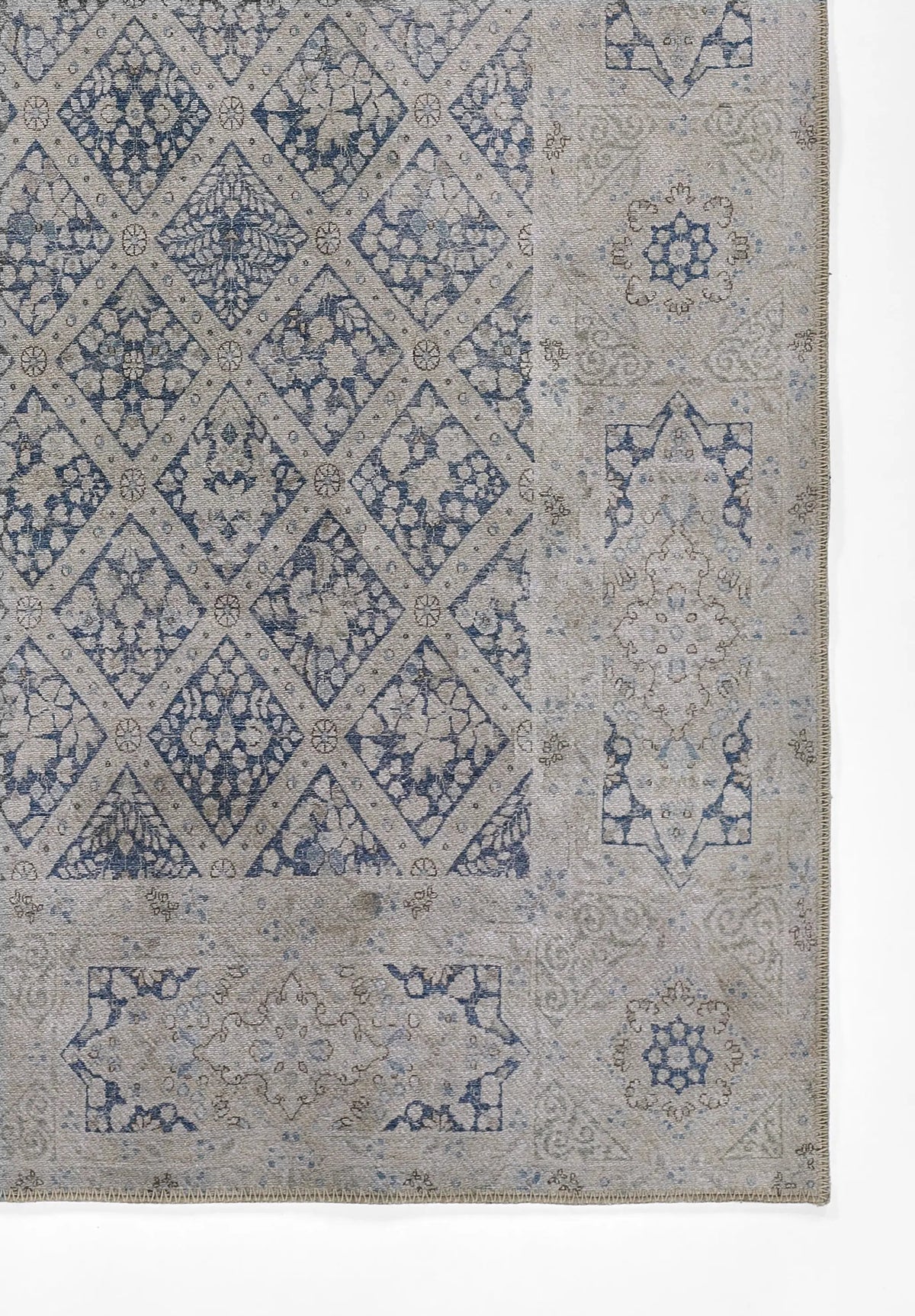 Erin Gates by Momeni Dorset DOR-3 blue and grey vintage-style area rug featuring a diamond lattice pattern with floral motifs and ornate borders.