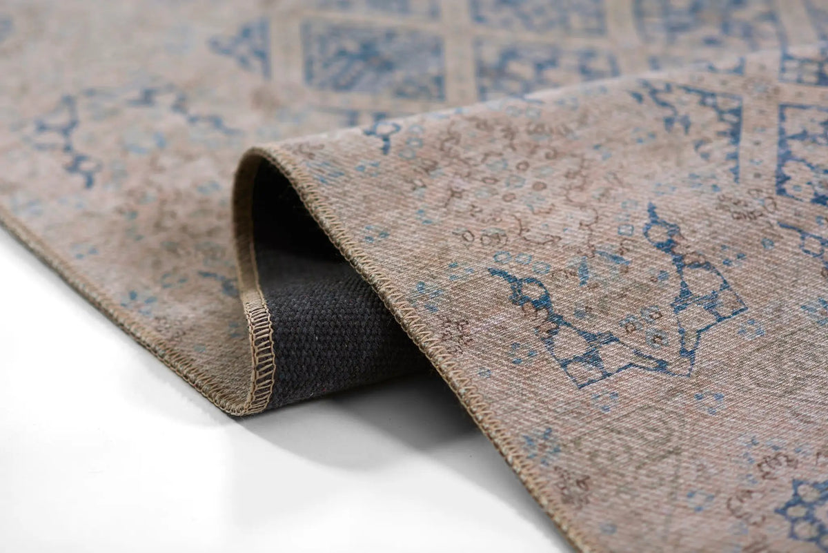 Erin Gates by Momeni Dorset DOR-3 blue area rug featuring vintage pattern, beige tones, stitched edge, and durable dark backing.