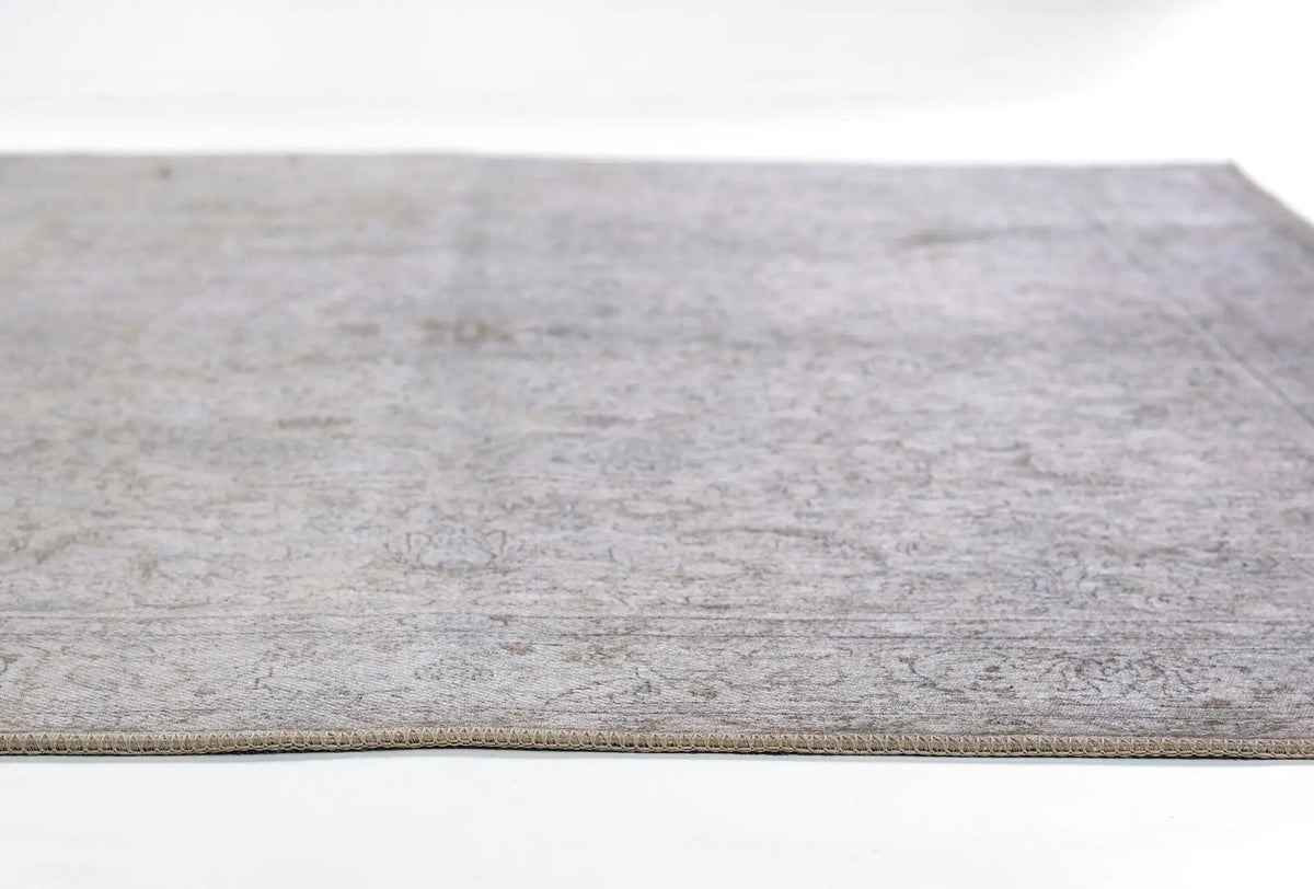 Erin Gates by Momeni Dorset DOR-4 gray area rug featuring a faded vintage medallion design, subtle distressing details, and a bound edge.